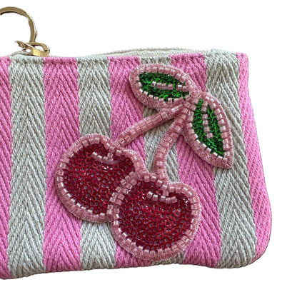 Pink and white striped cherry coin purse featuring sparkling beaded cherries with sequins, a pink tassel, and gold-tone keychain clip.