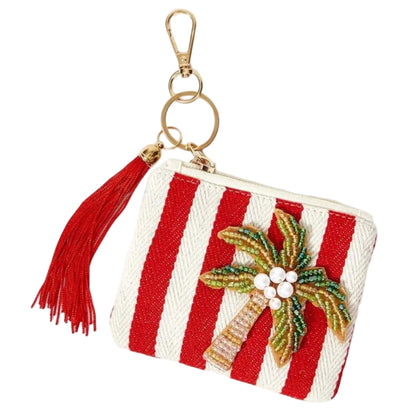 Red and white striped tropical coin purse featuring sparkling beaded palm tree with a red tassel, zipper closure and gold-tone keychain clip.
