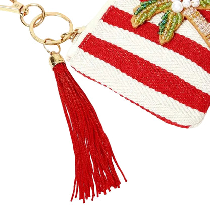 Red and white striped tropical coin purse featuring sparkling beaded palm tree with a red tassel, zipper closure and gold-tone keychain clip.