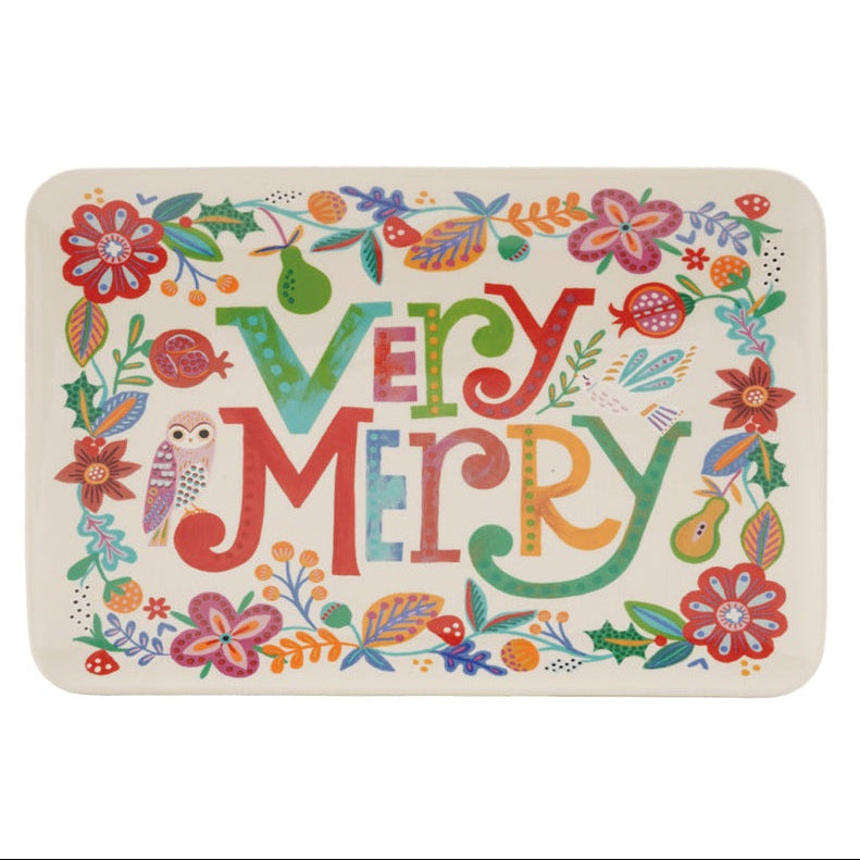 Rectangular stoneware platter with colorful “Very Merry” lettering, festive botanicals, fruit, mushrooms, and an owl.