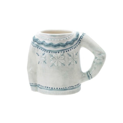 Pale blue stoneware sweater-shaped mug decorated with dimensional snowflakes and blue trim.