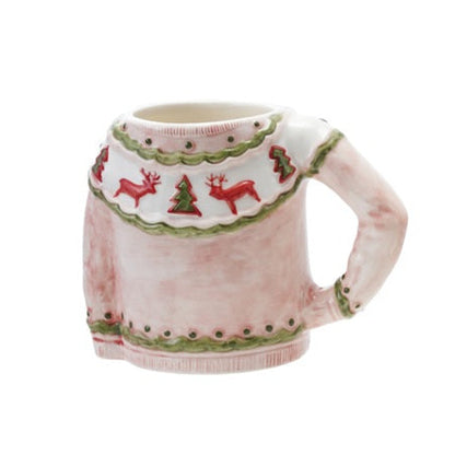 Pinkish red stoneware sweater-shaped mug decorated with red reindeer, Christmas trees, and green trim.