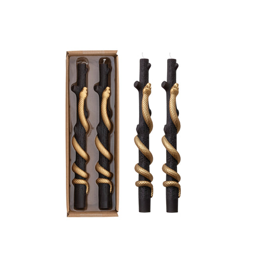 Set of black and gold twisted sticks with packaging on a white background