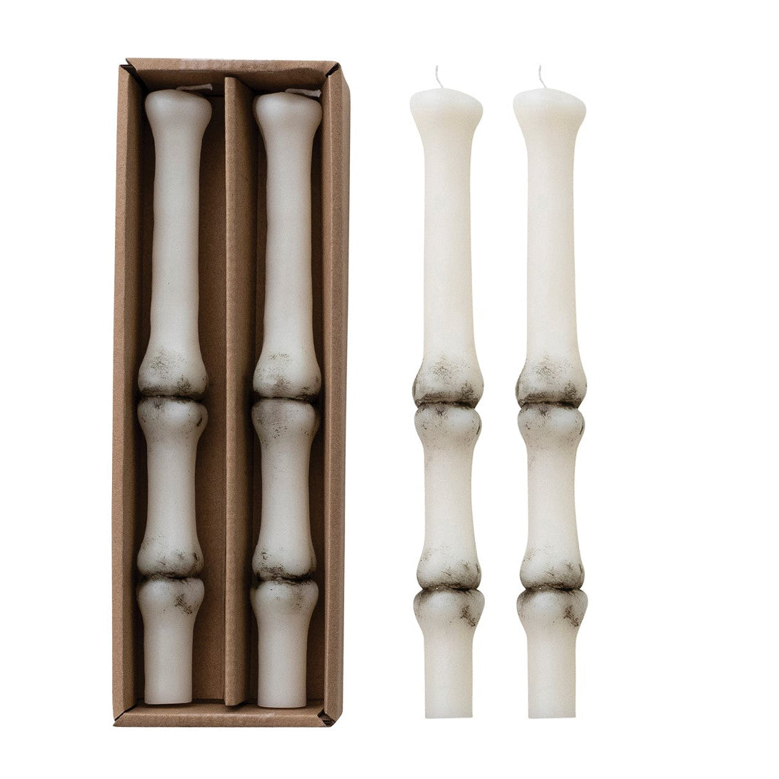 Set of white candlesticks with a cardboard box on a white background