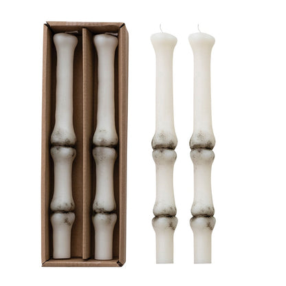 Set of white candlesticks with a cardboard box on a white background