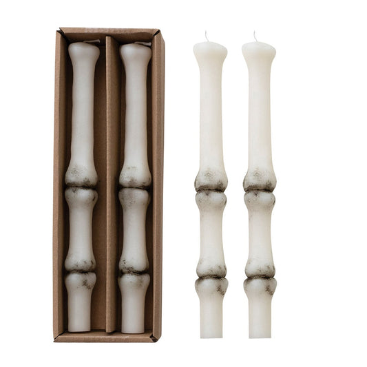 Set of white candlesticks with a cardboard box on a white background
