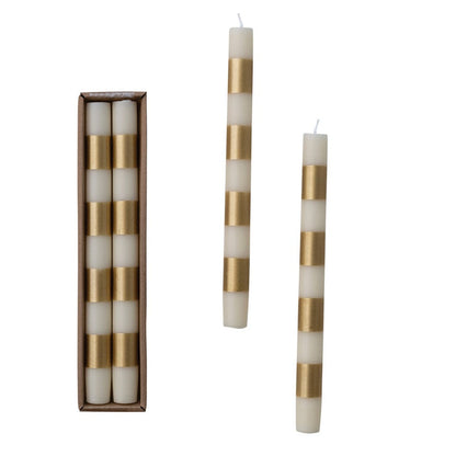 Set of white candles with gold stripes in a box on a white background