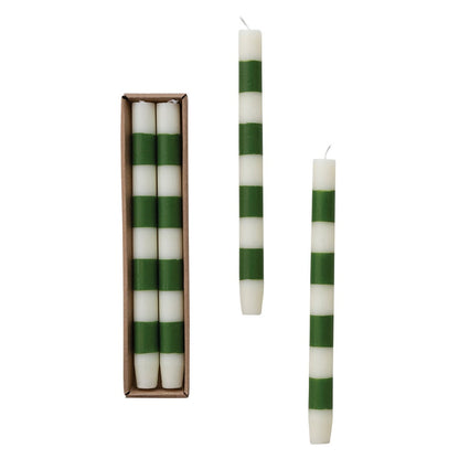 Set of two 10-inch cream and green striped taper candles displayed beside their kraft box.