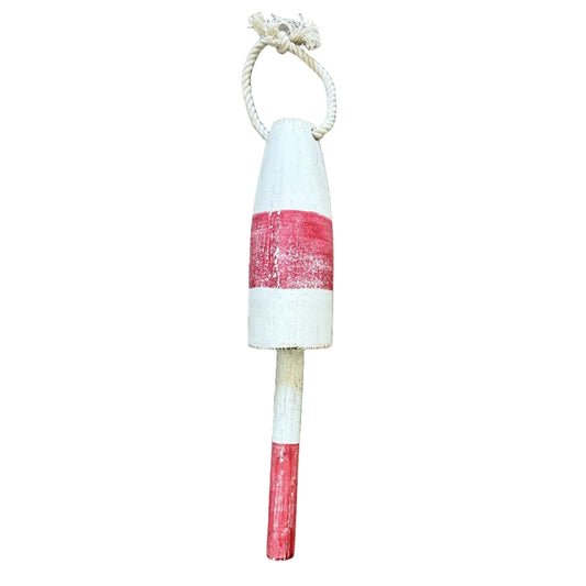 Decorative buoy with red and white stripes on a wooden surface
