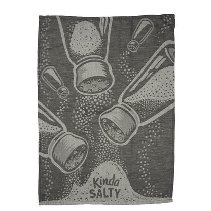 A rectangular dark gray towel featuring a stylized graphic print of salt and pepper shakers spilling salt and pepper, with the text 'Kinda SALTY' at the bottom.