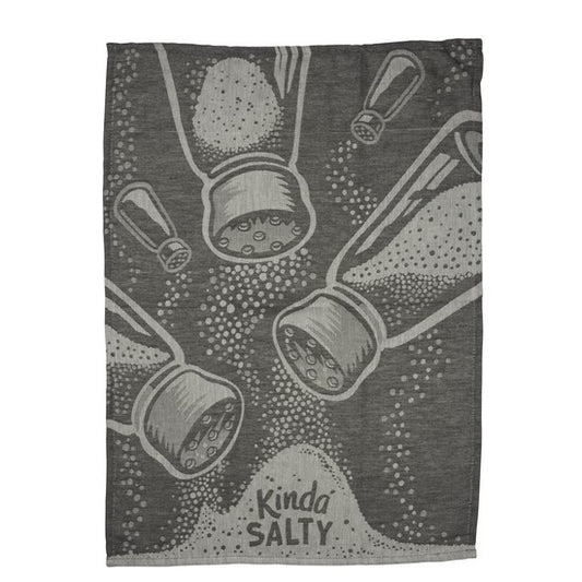 A rectangular dark gray towel featuring a stylized graphic print of salt and pepper shakers spilling salt and pepper, with the text 'Kinda SALTY' at the bottom.