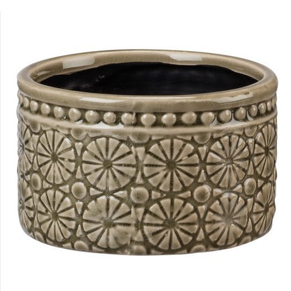 A taupe stoneware pot with textural medallion designs